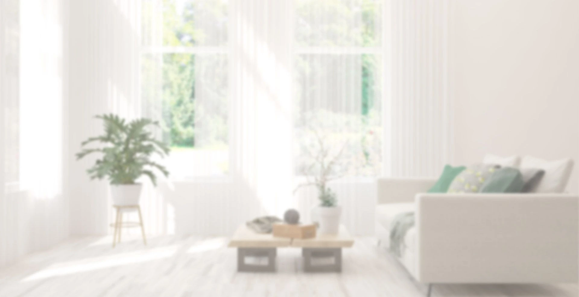A blurry photo of a living room with white furniture.