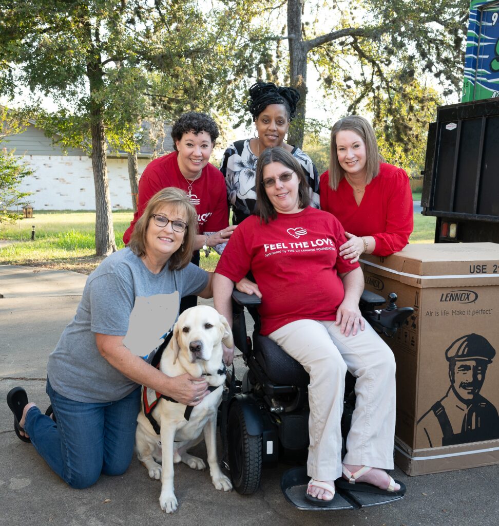 A group of people with a dog and some boxes