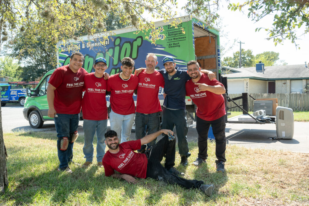 A group of men in red shirts posing for the camera.